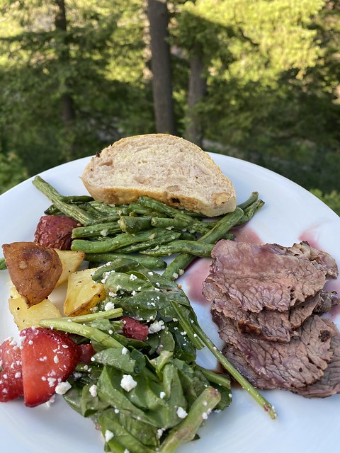 Dinner plate includes beef trii-tip, green beans, roasted potatoes, greek salad, homemade bread.