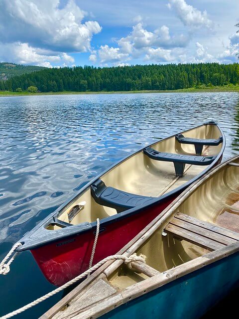 Two canoes are tied up at the floating dock on Spencer Lake at the Bar W Guest Ranch in Whitefish, Montana.