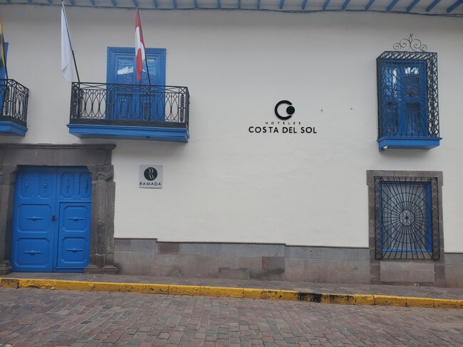 Blue doors and windows against a white wall mark the entrance to Costa del Sol