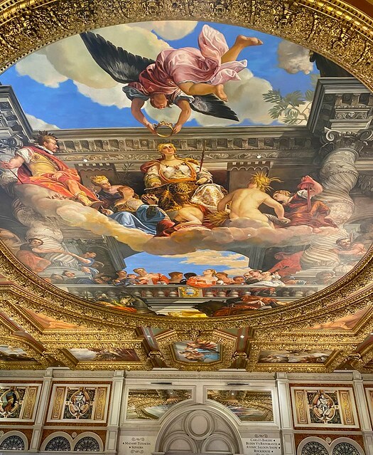 Hand-painted mural of an angel placing a crown on the head of a woman. The mural on the ceiling is on display in the Grand Colonnade inside the Venetian Las Vegas. 