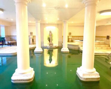 Roman-style pool and hot tub on lower level.