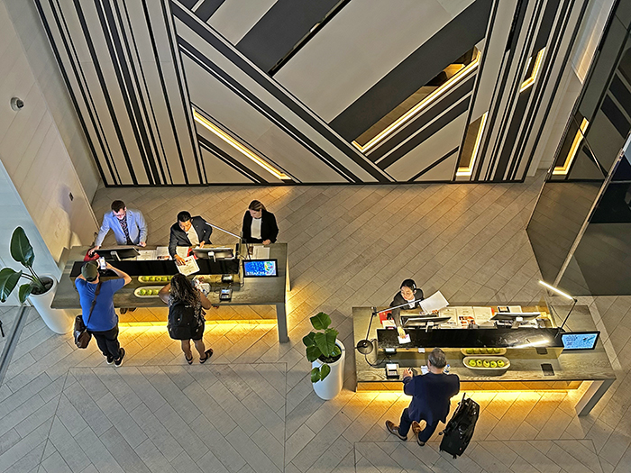 View down onto check-in desks with graphic wall design