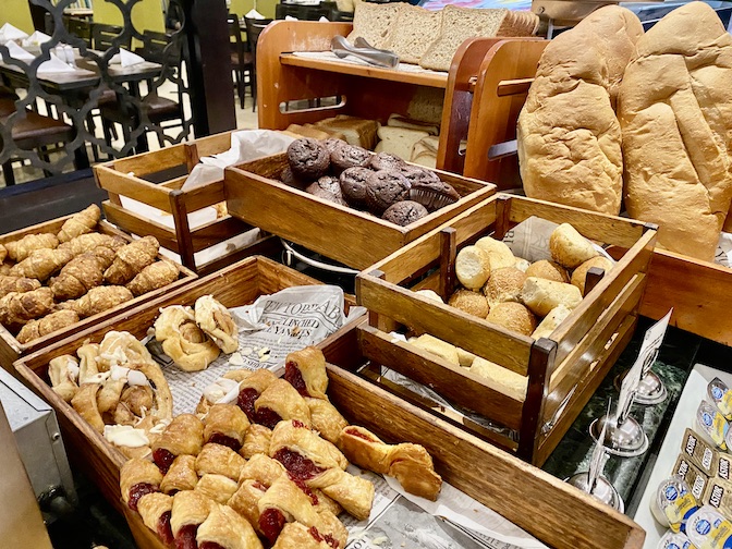 Freshly baked breads and pastries accompany breakfast.
