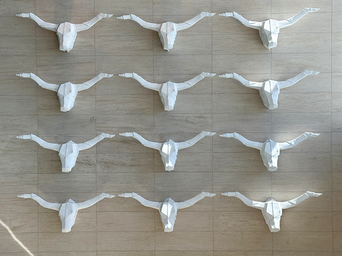 A wall of longhorn skull sculptures decorates the lobby of the Renaissance Dallas Plano