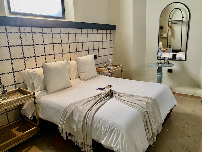 Rooms have high ceilings and tiled floors at Privado Boutique Rooms hotel.