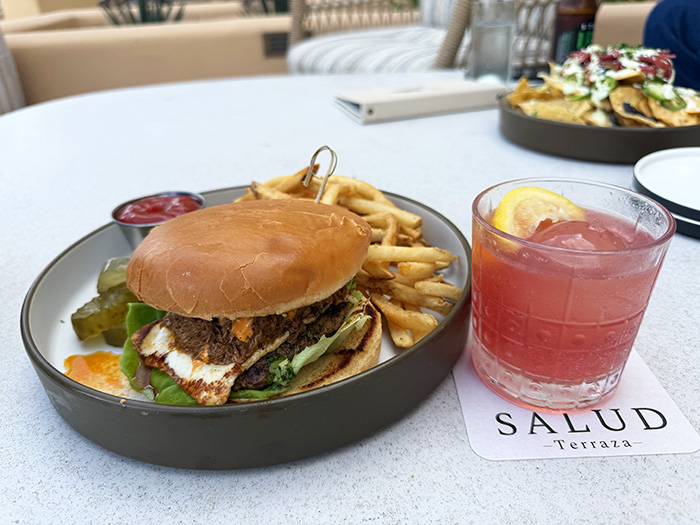 The Birria Burger and cocktail at Salud, the terrace dining option at Tucson Desert Starr Pass